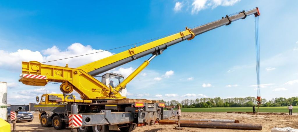 Mobile crane positioned on a construction site for a planned contract lifting operation in Canada.